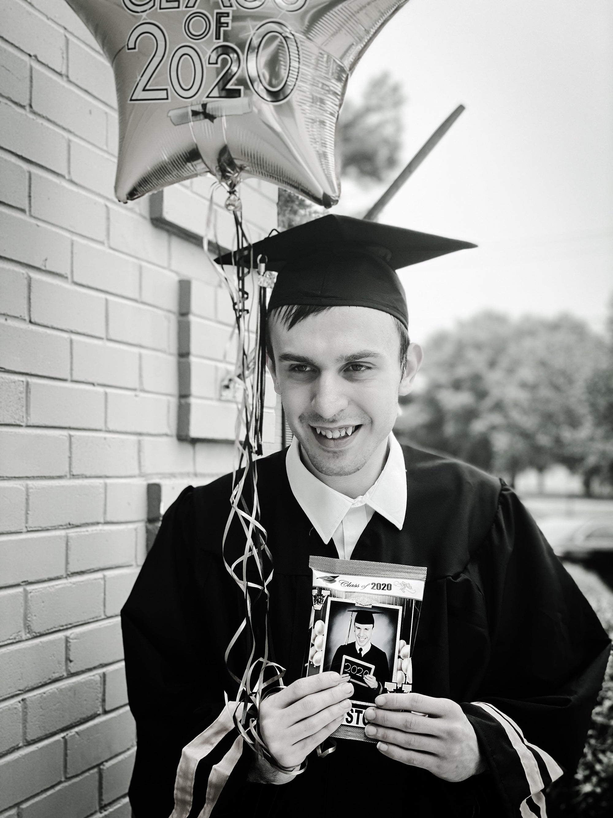 Theo celebrates his graduation day in his cap and gown