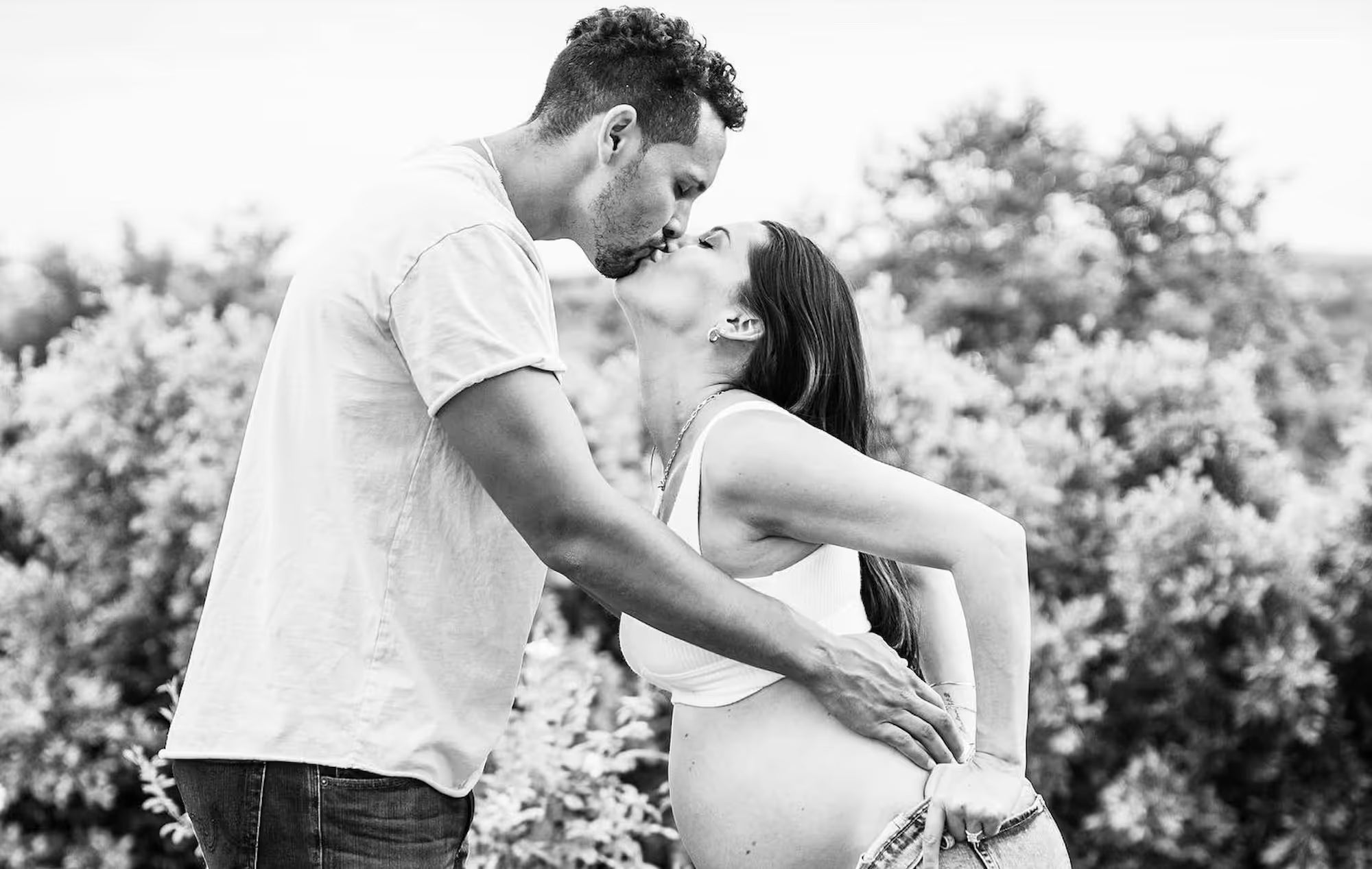 Becca Kufrin and fiance embracing at wedding event