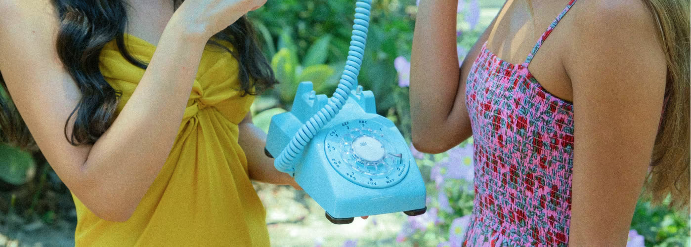 2 girls holding audio guestbook for baby shower