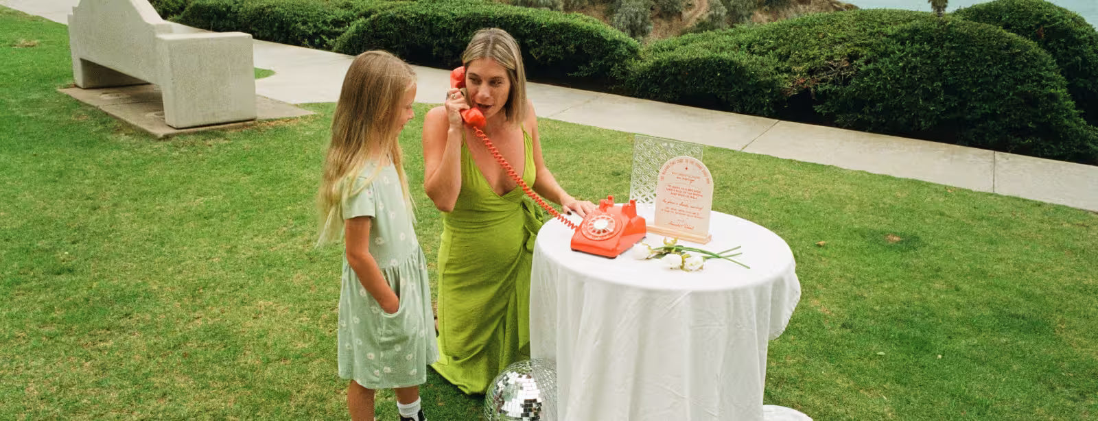 Mom and daughter speaking into phone audio guestbook