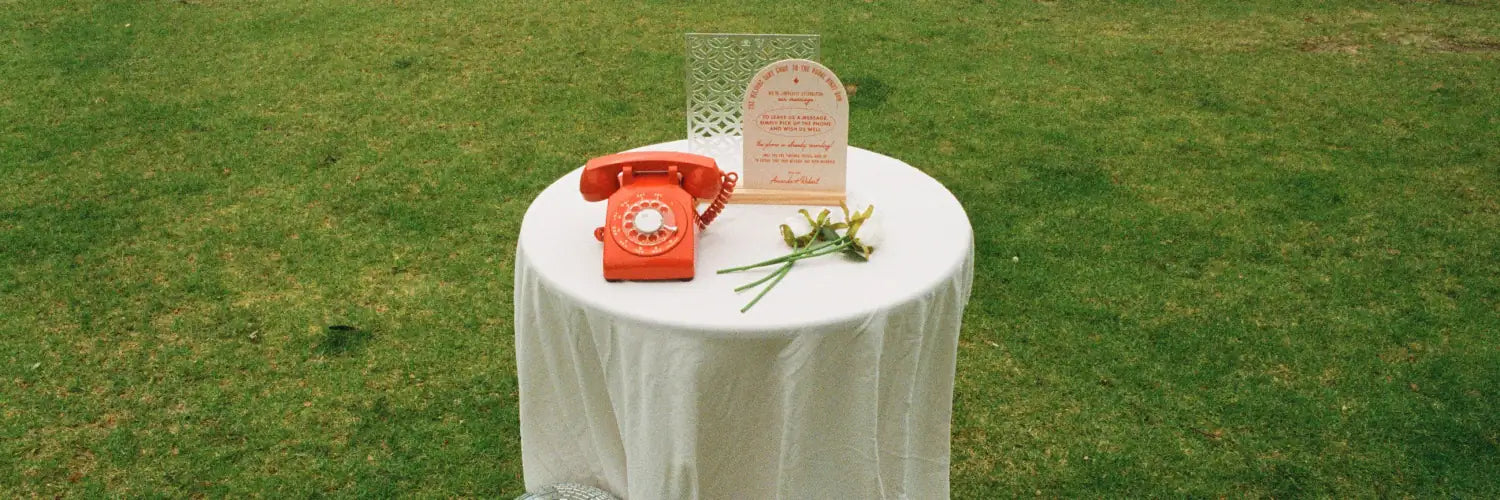 Orange phone audio guestbook sitting on table