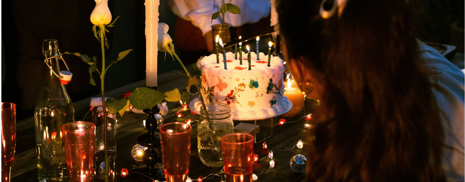 Birthday cake surrounded by candles in the dark