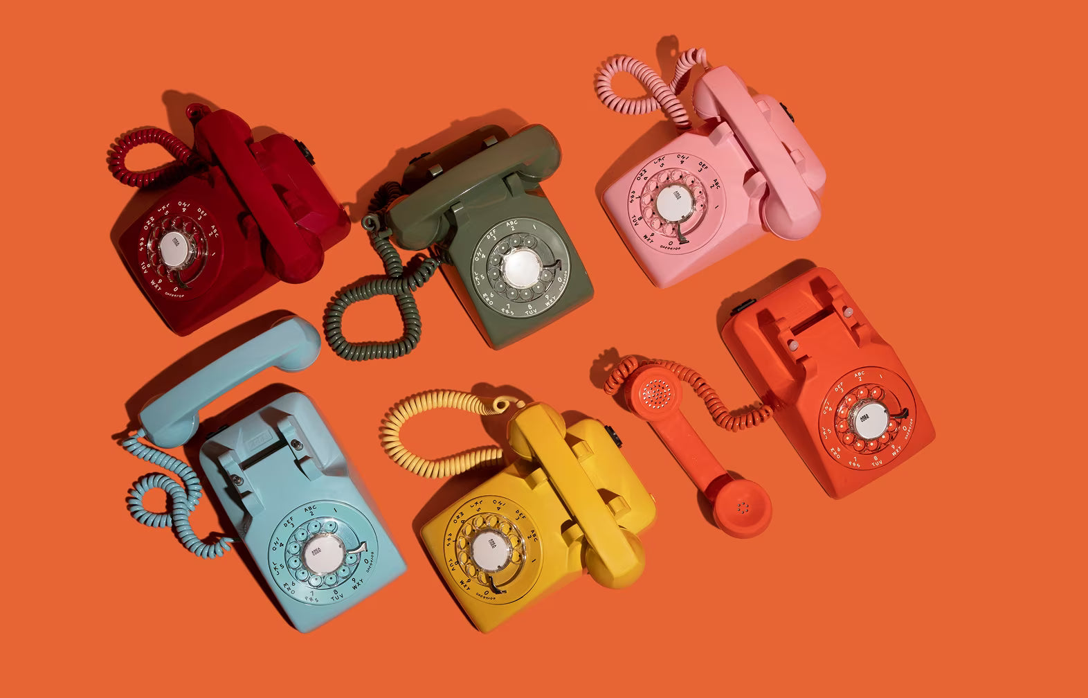 phone guestbooks laying down on orange background