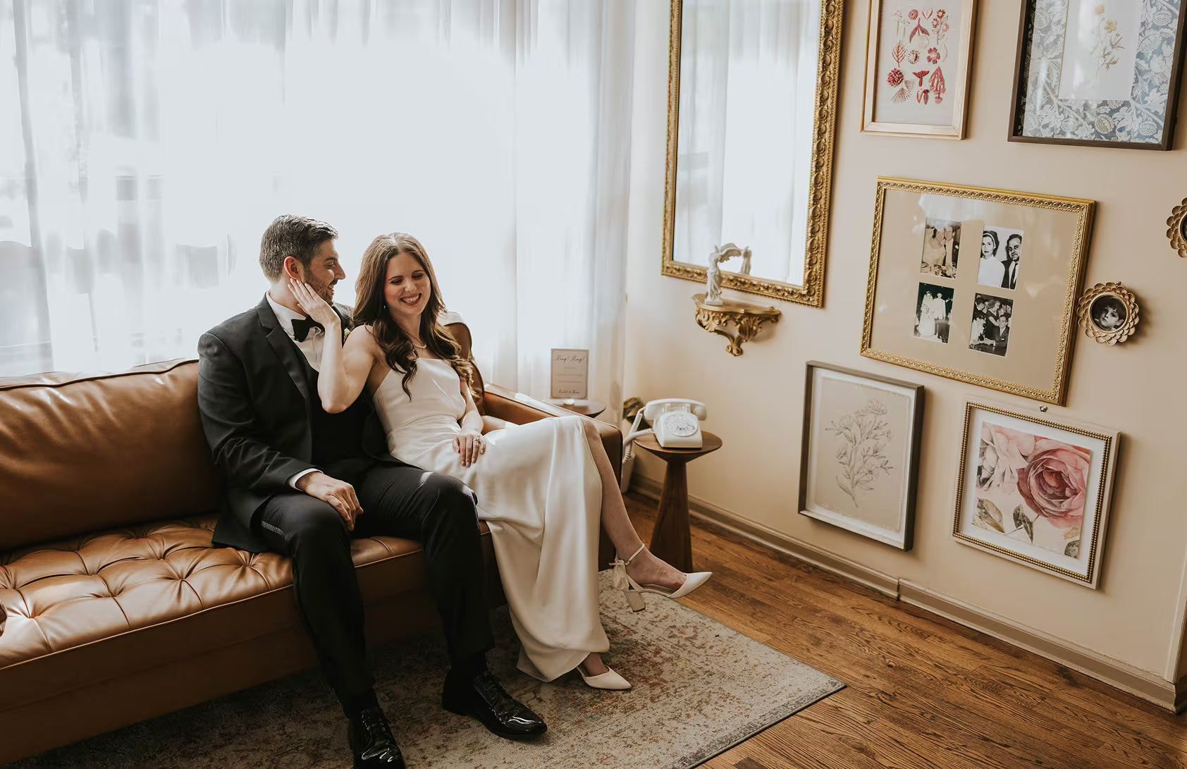 HUsband and Wife on couch next to white phone audio guestbook
