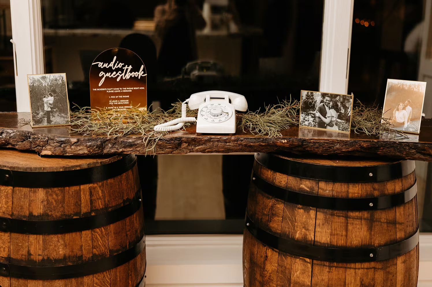White phone audio guestbook on wood wedding table