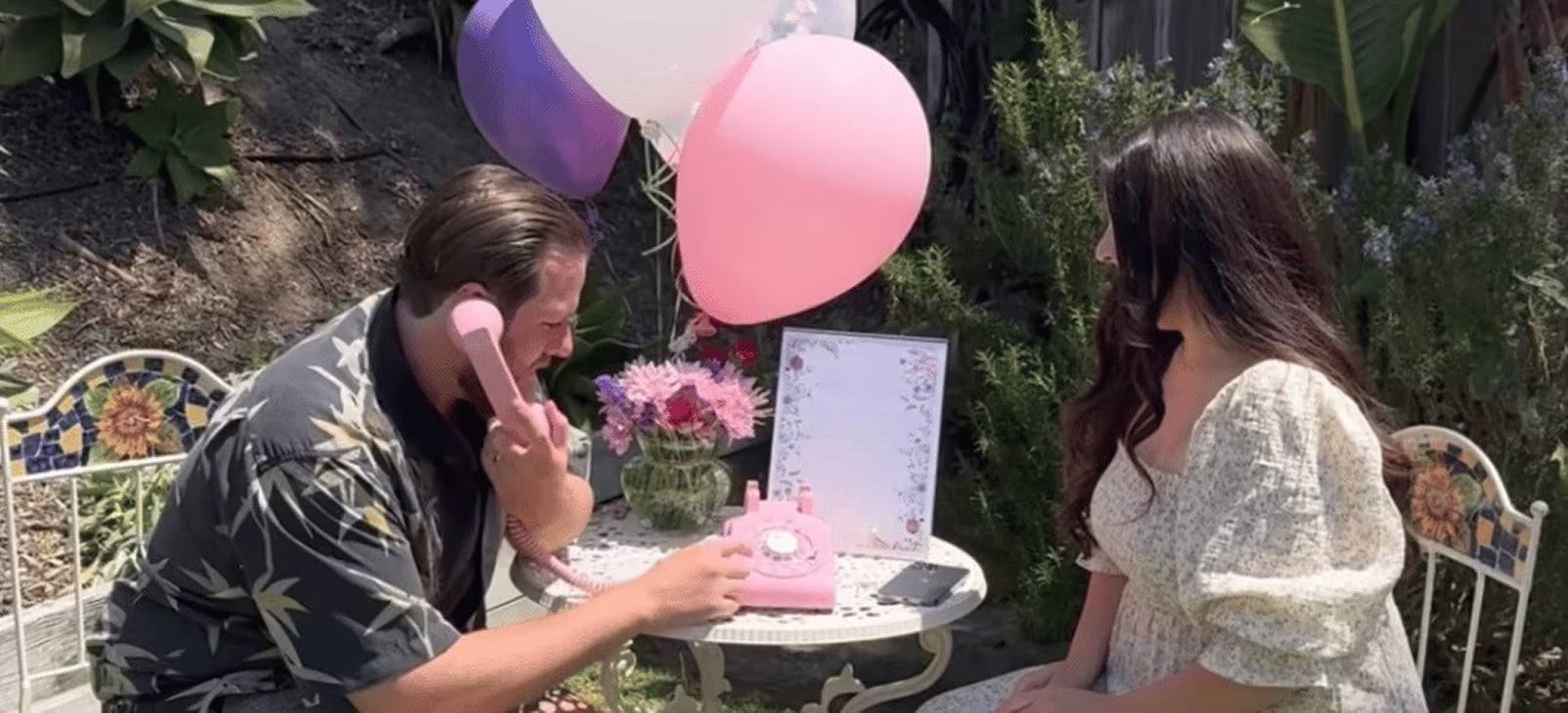 two people sitting down for first birthday party