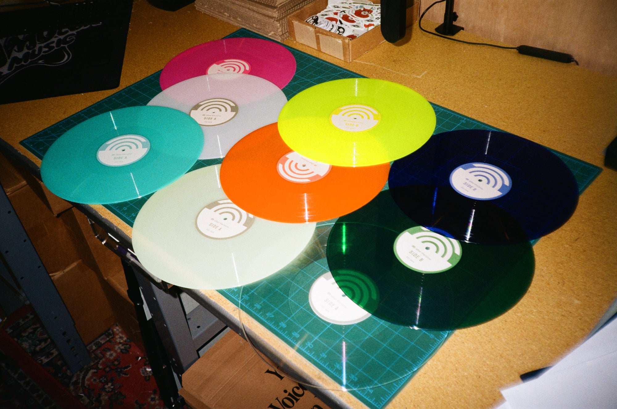 Vinyl of different colors sit at studio waiting to be shipped
