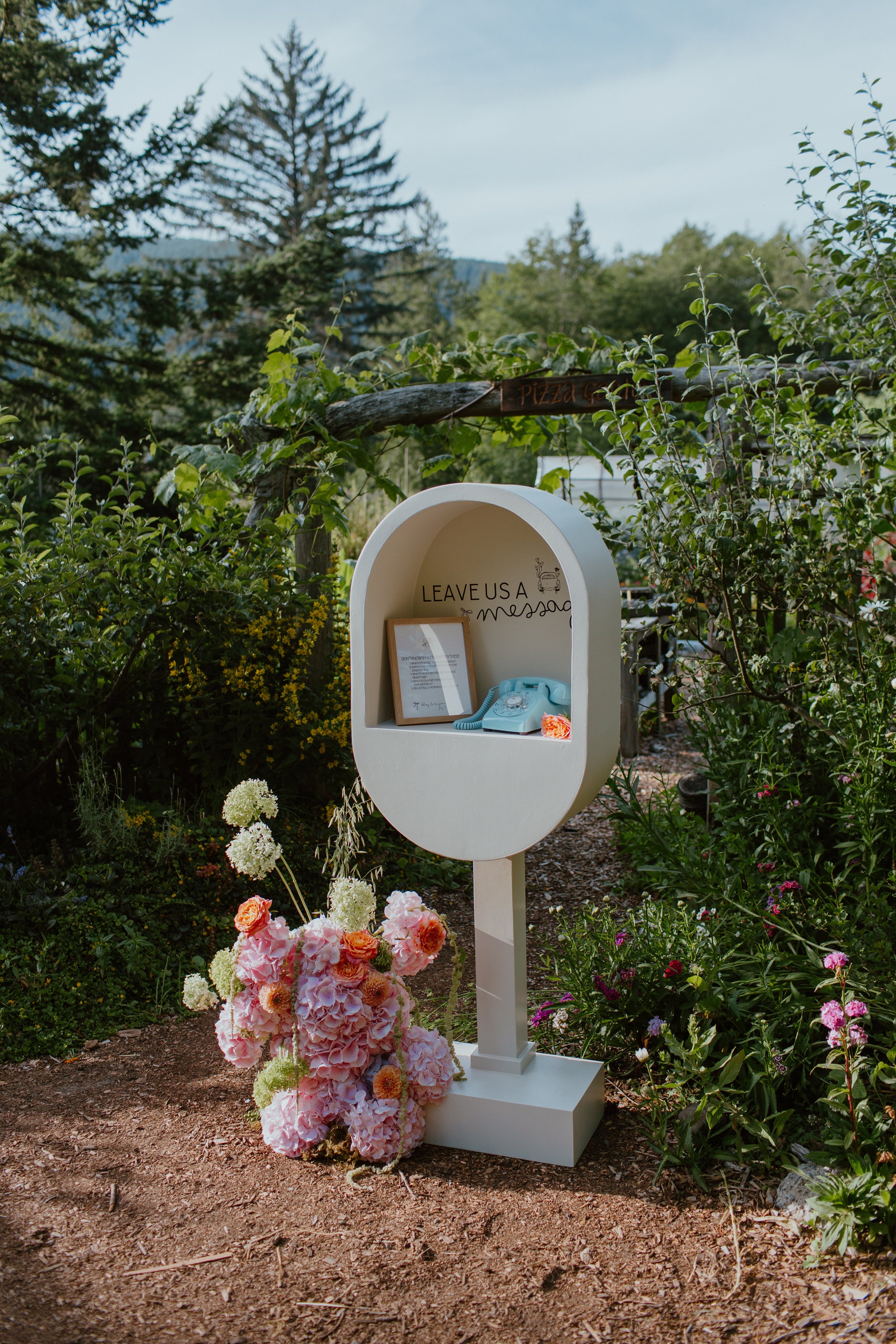 Blue rotary phone station in cream phone booth at wedding