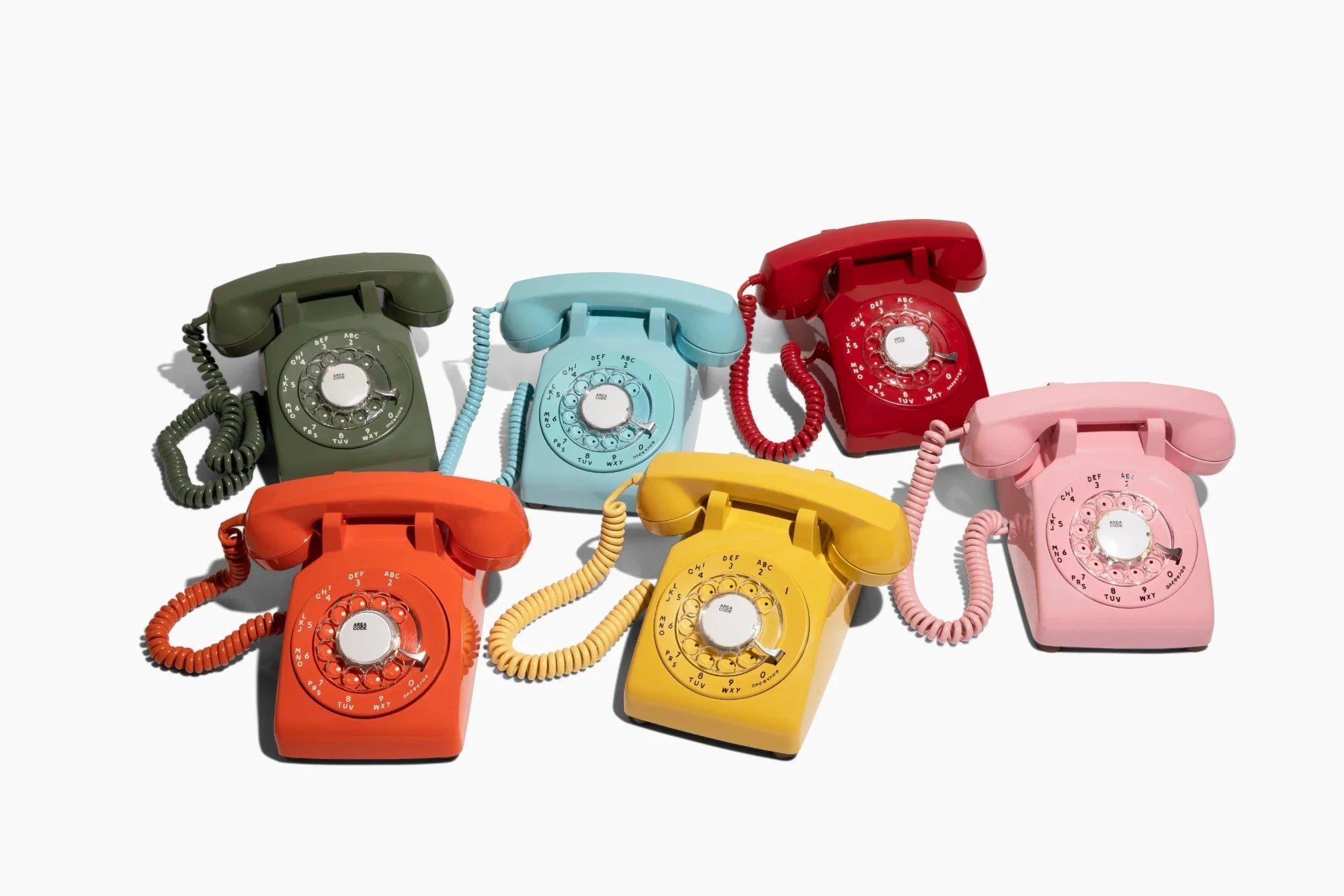 six colorful vintage audio guest book phones on a white background