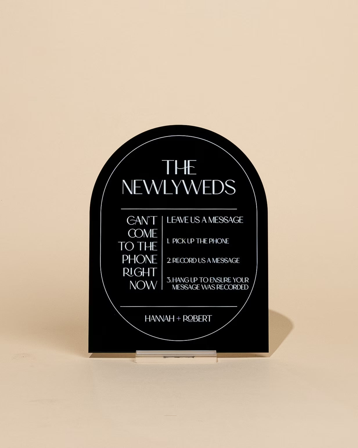 Black plaque with white text on a beige background
