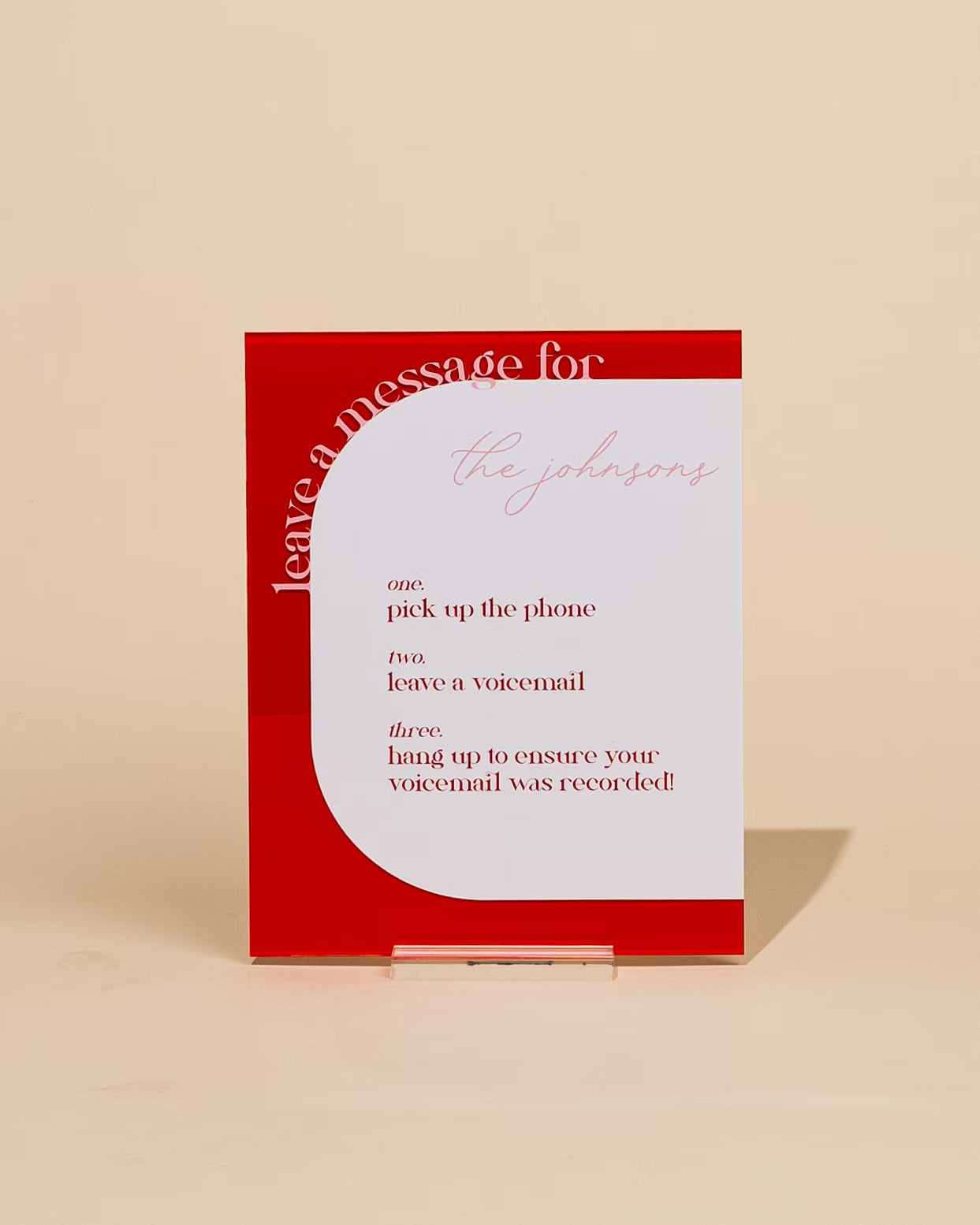 Red and white sign with humorous voicemail instructions on a beige background