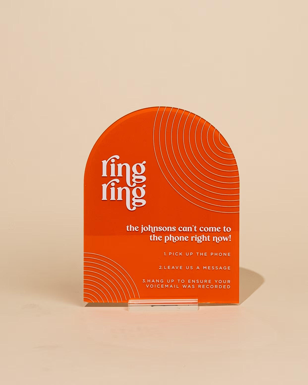 Orange phone message board with white text on a beige background