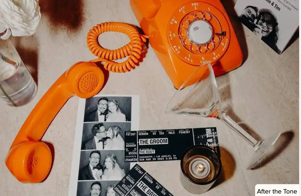 orange rotary phone on a table with a martini glass