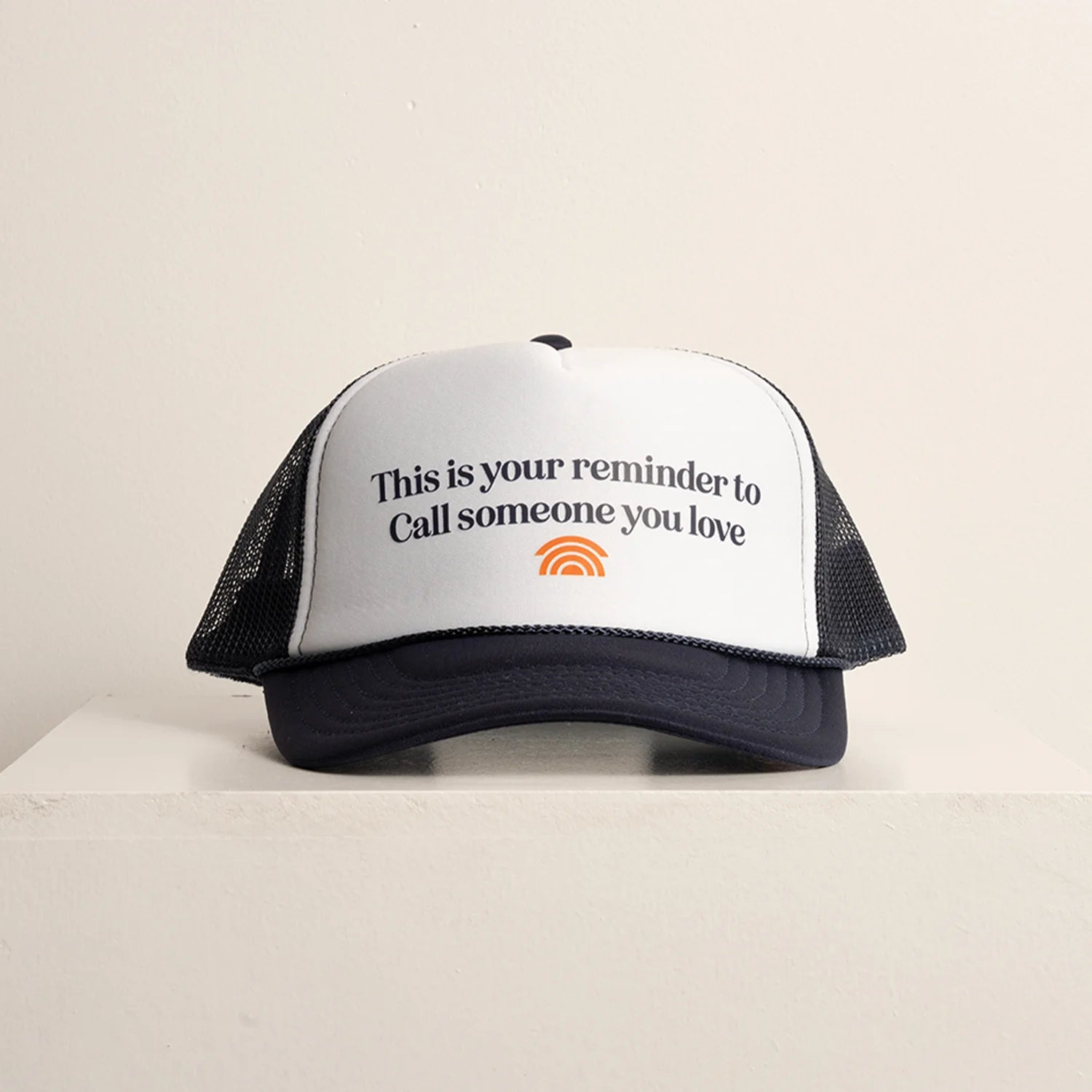 Trucker hat with text and logo on a beige background