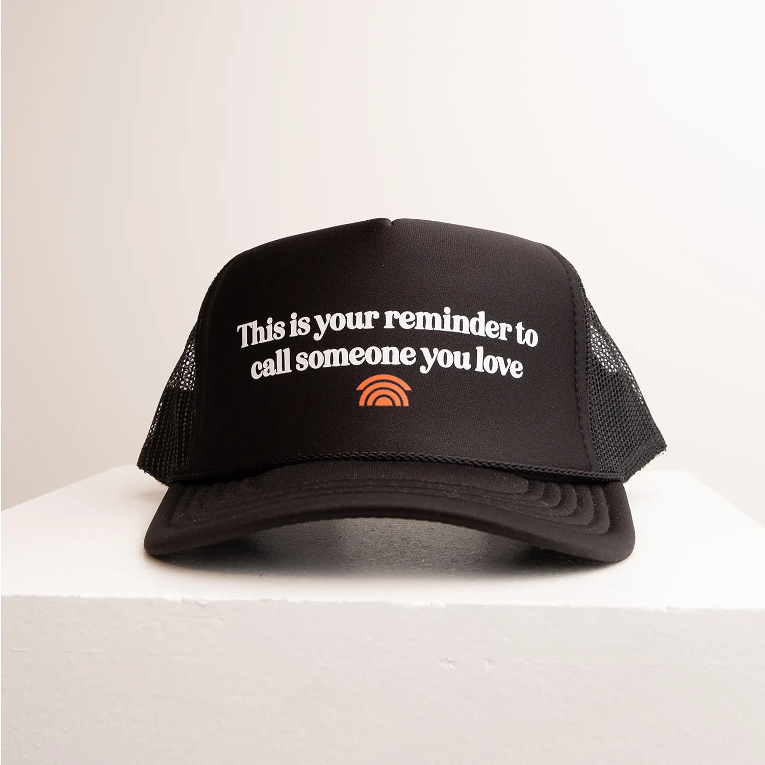 Black trucker cap with text and logo on a white background