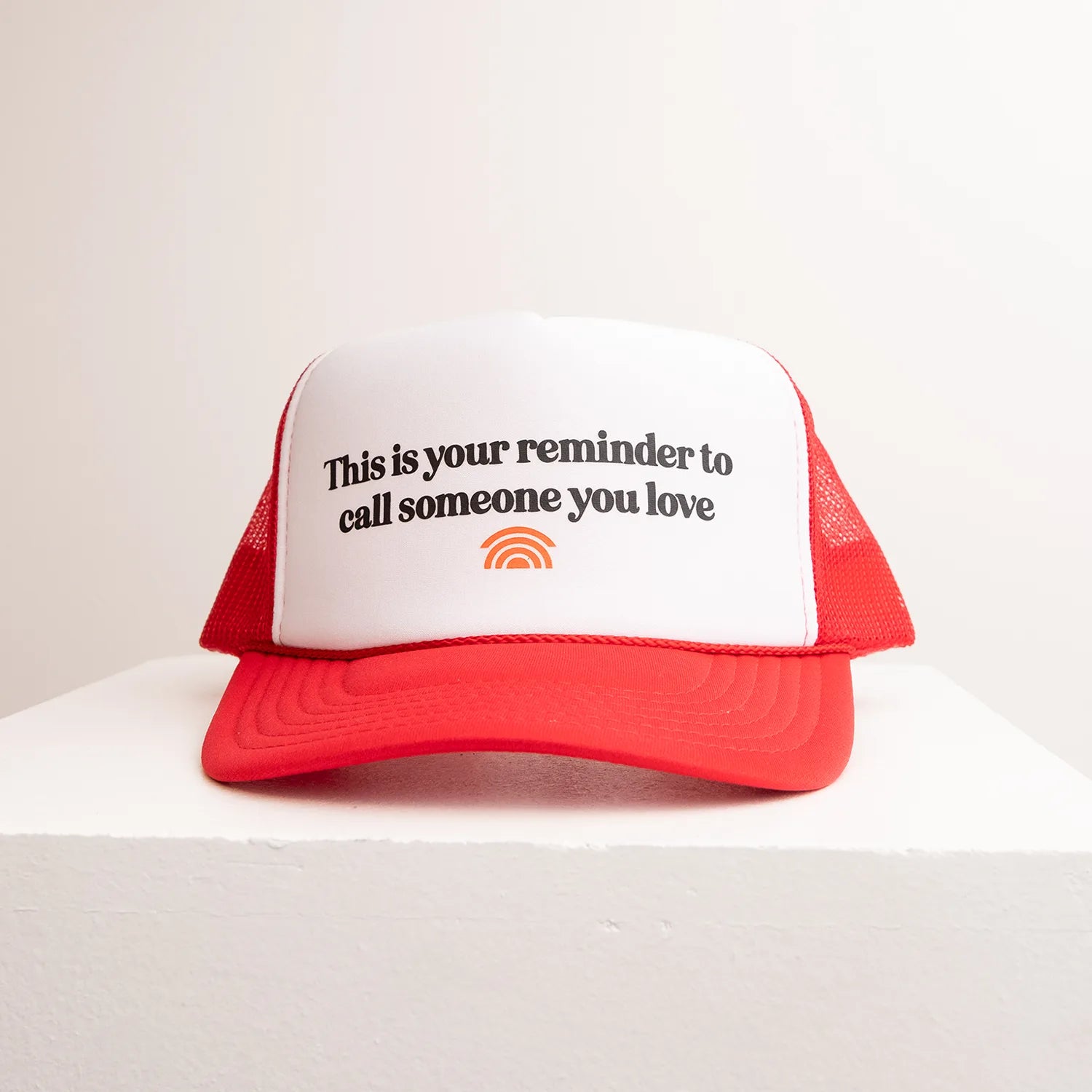 Red and white cap with text on a white background