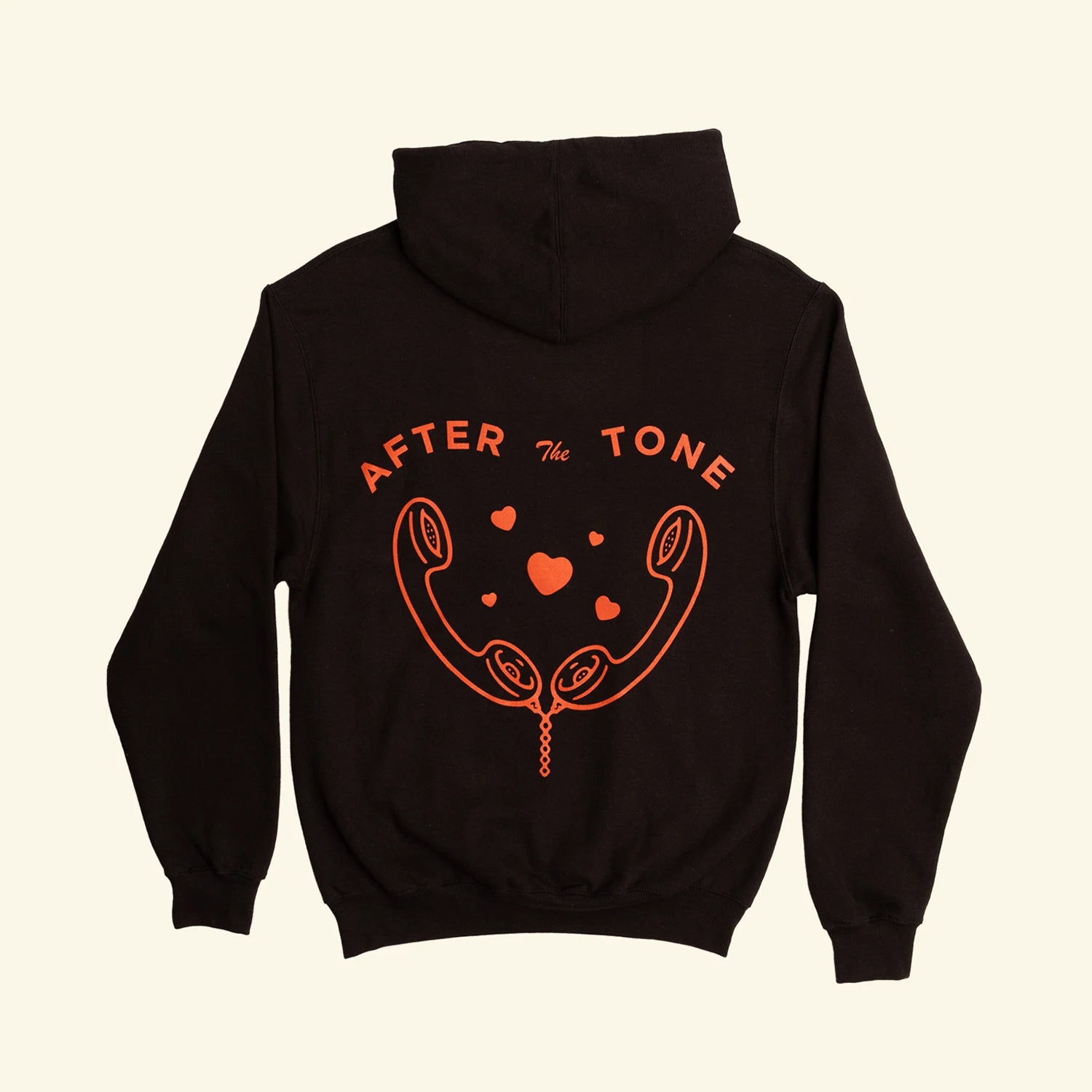 Black hoodie with red graphic and text on a beige background