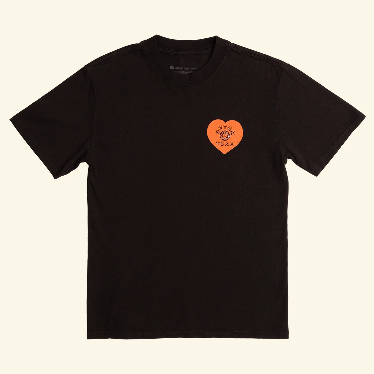 Black t-shirt with an orange heart-shaped logo on a beige background