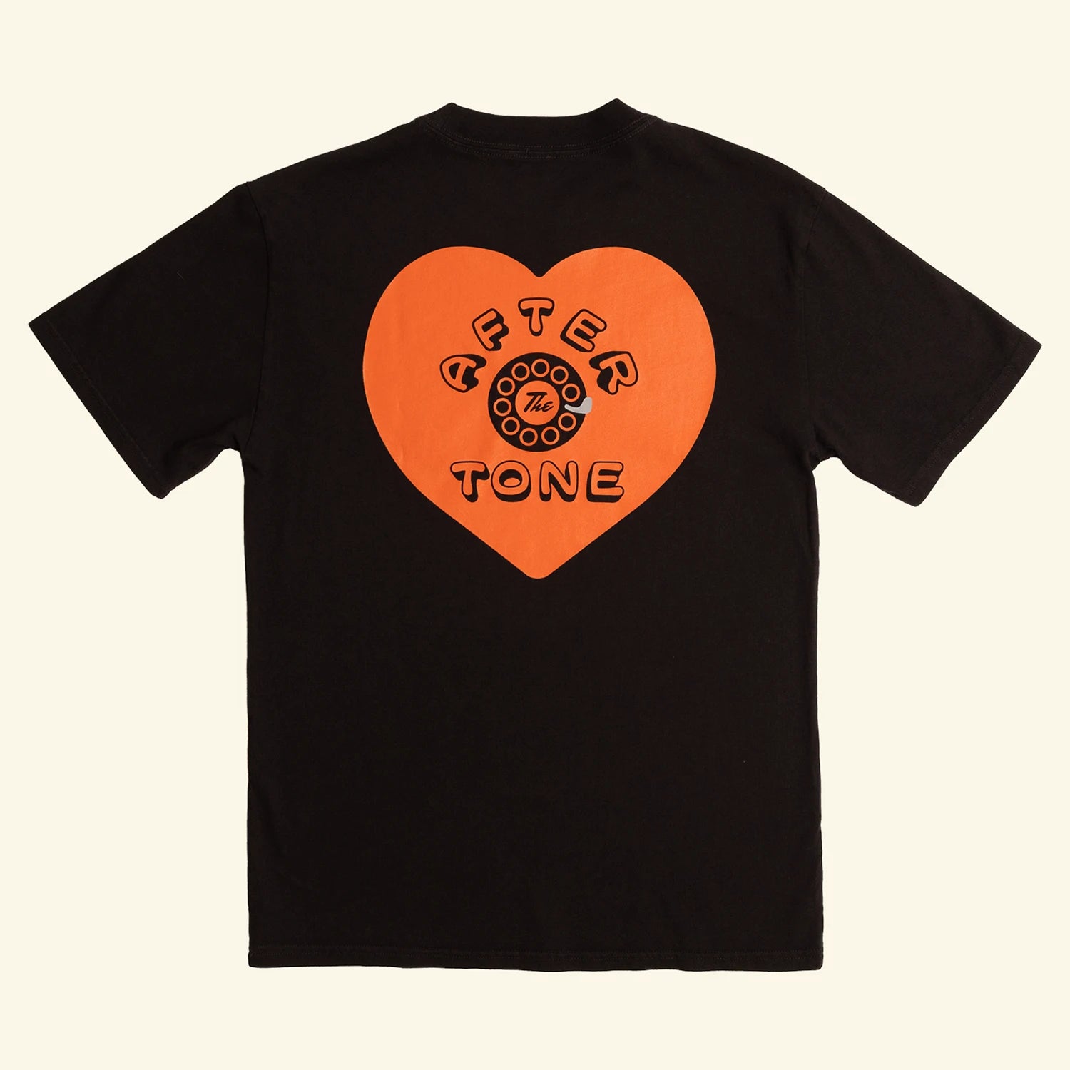 Black t-shirt with an orange heart-shaped logo on a beige background