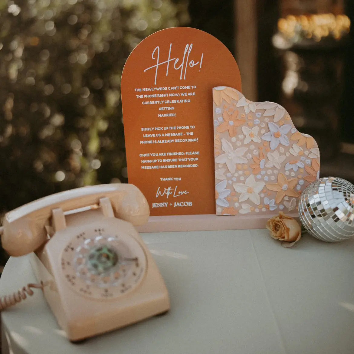 Beige Vintage-style phone with a decorative card on a table