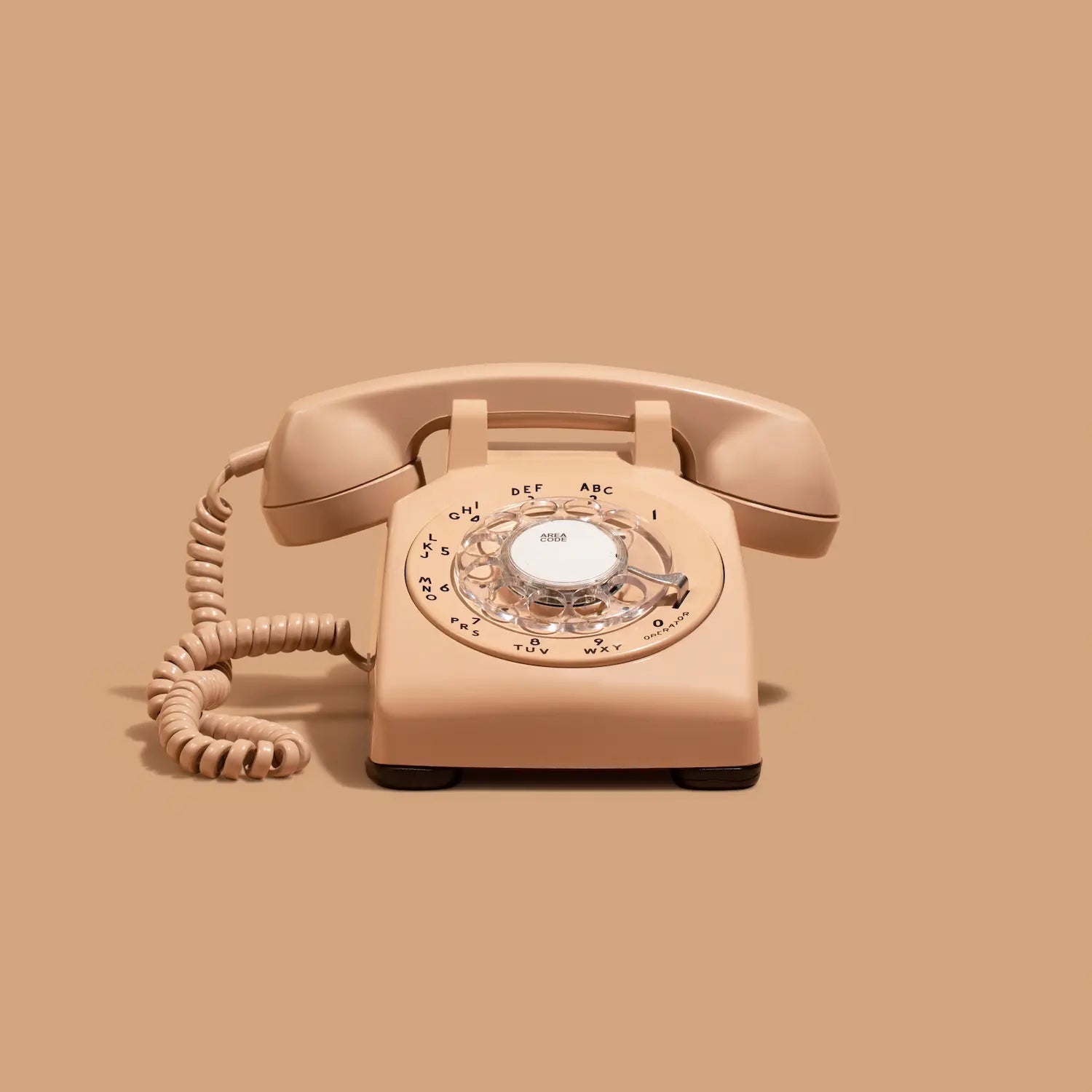 Beige rotary phone audio guestbook on a beige background