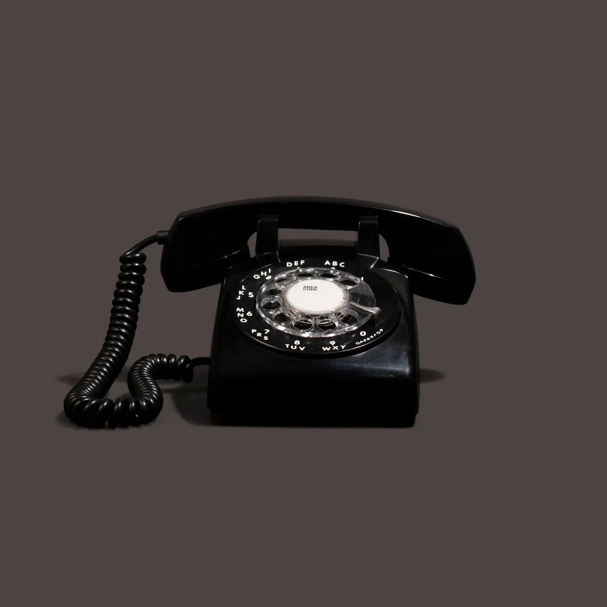 Black rotary phone audio guestbook on a black background.