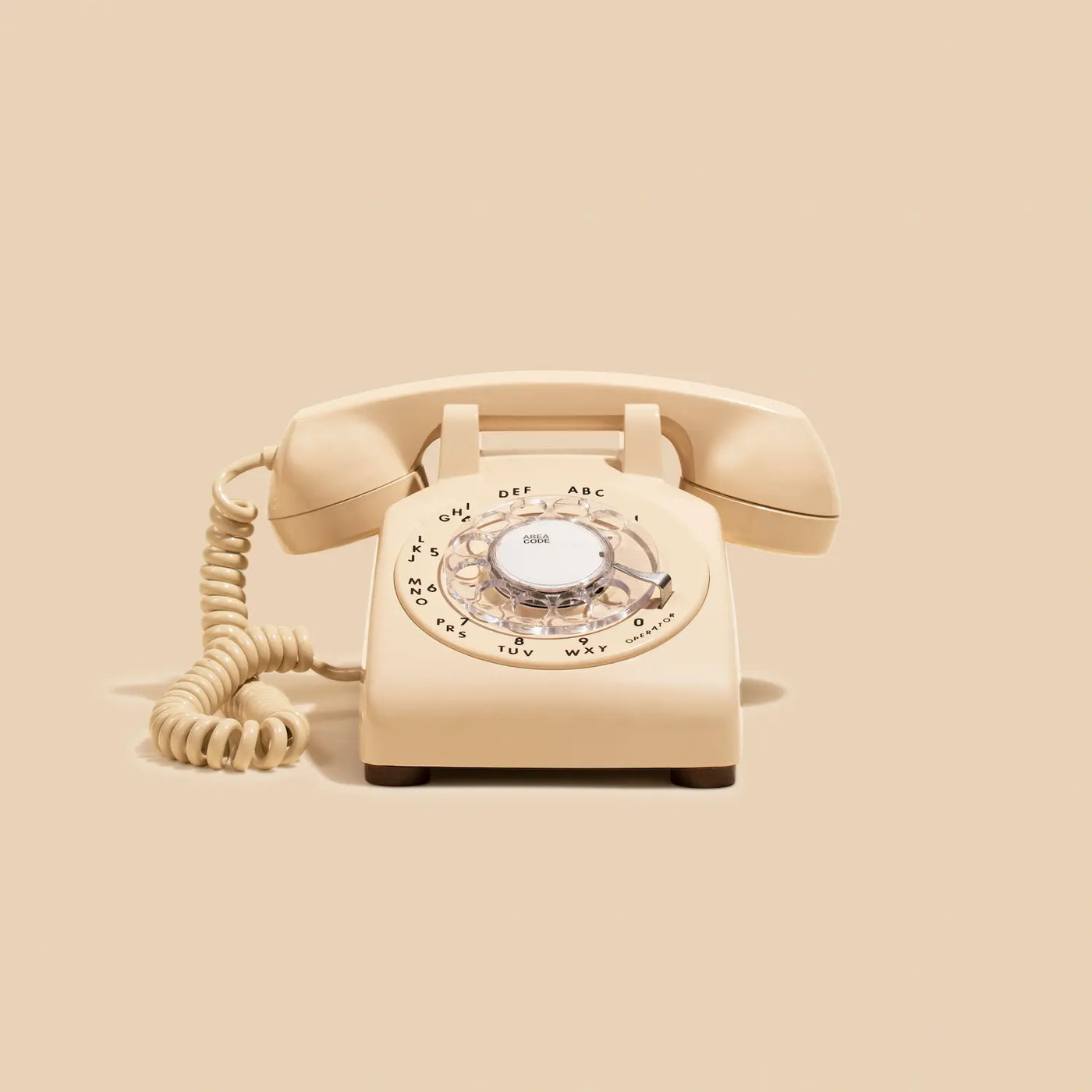 Beige rotary phone on a beige background