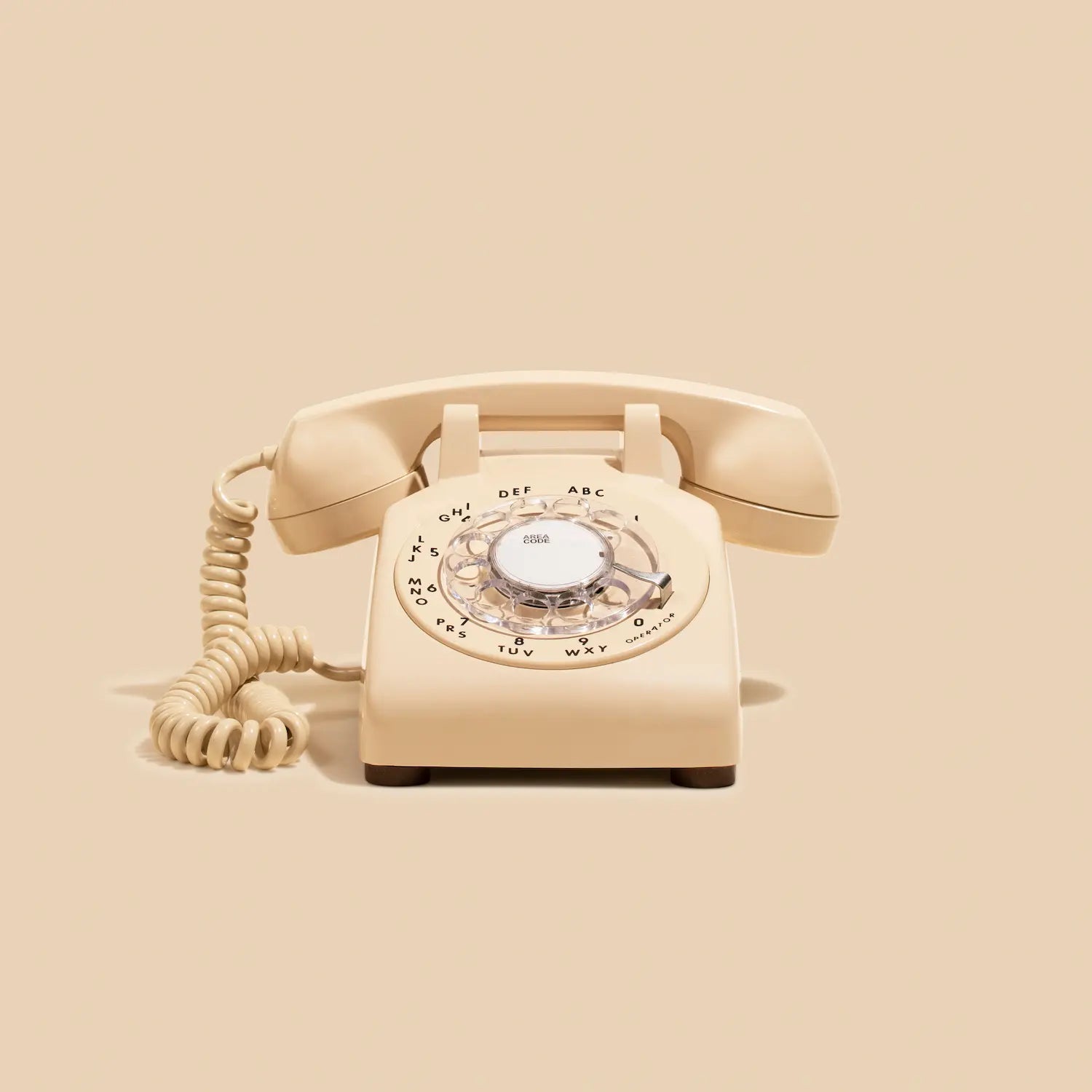 Beige rotary phone on a beige background
