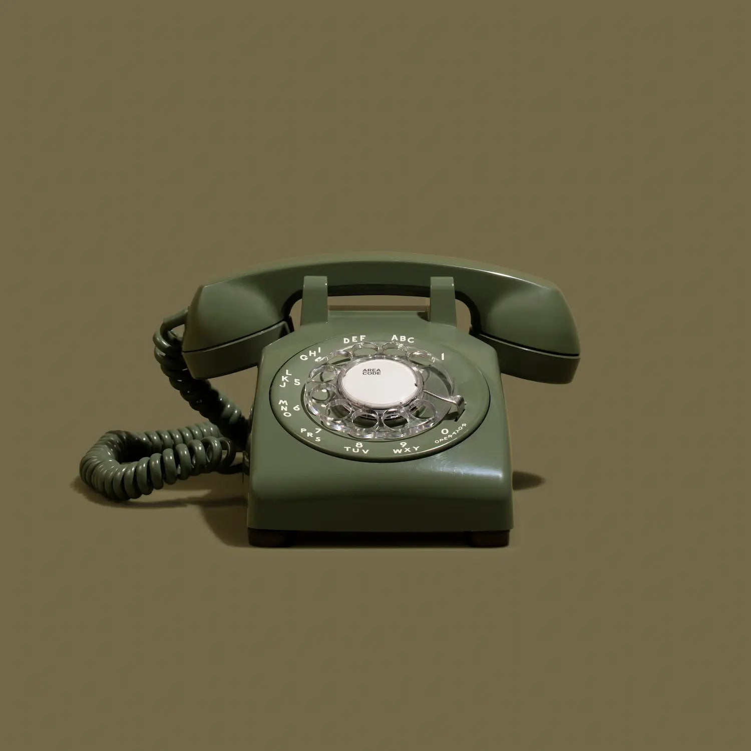 Green rotary phone on a brown background