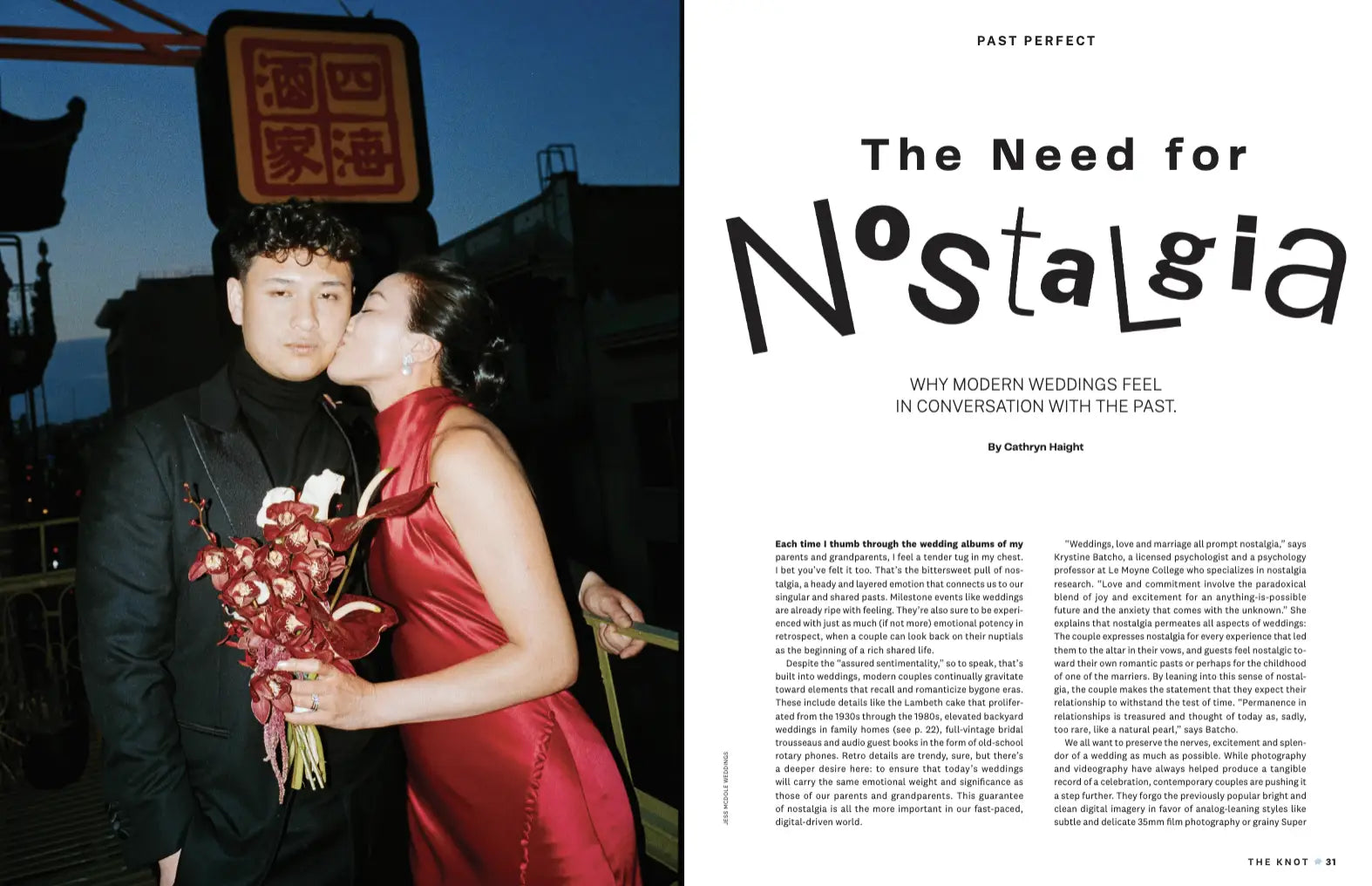 a couple hugging holding red flowers