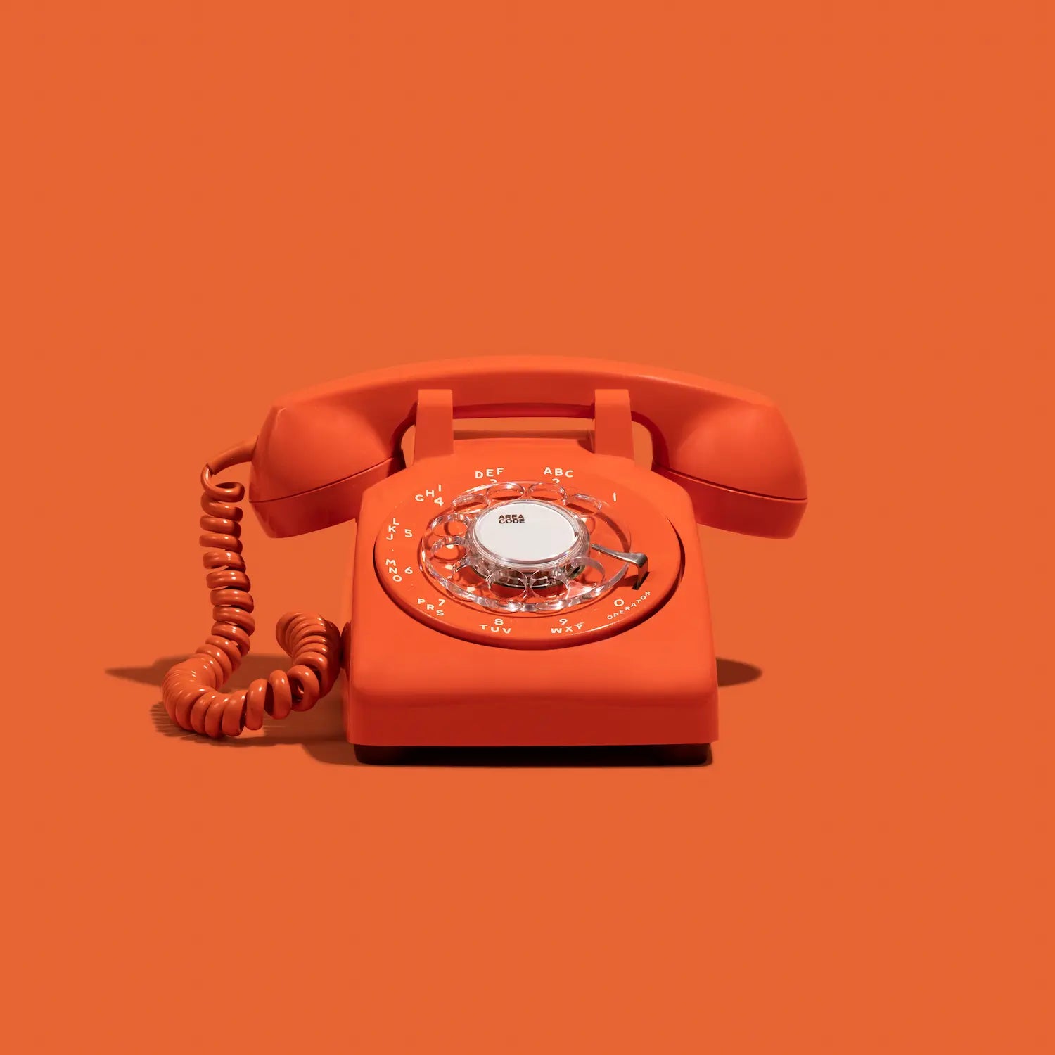 Orange rotary phone audio guestbook on an orange background
