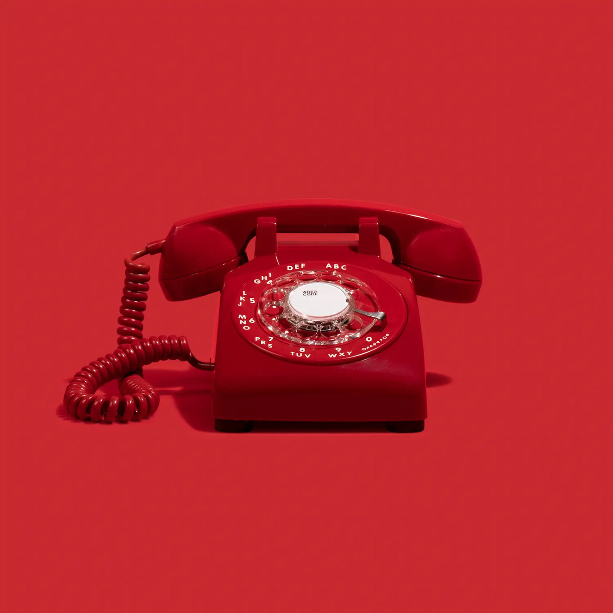 Red rotary phone audio guestbook on a red background